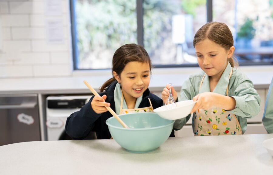 Two students cooking in kitchen
