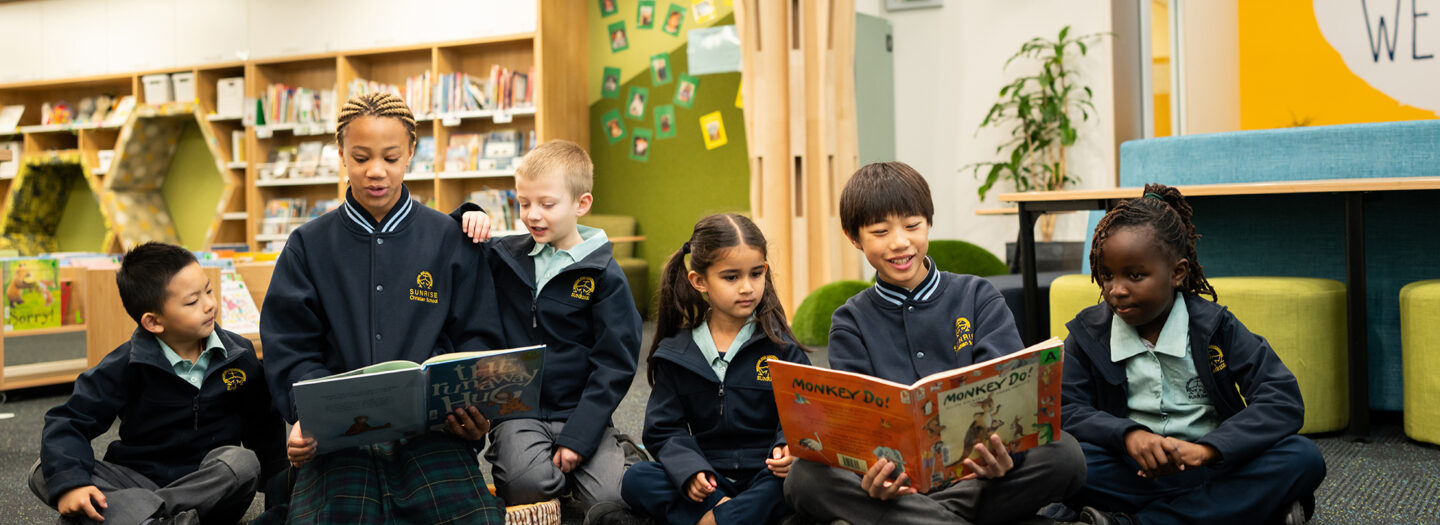 Buddies reading together in the library