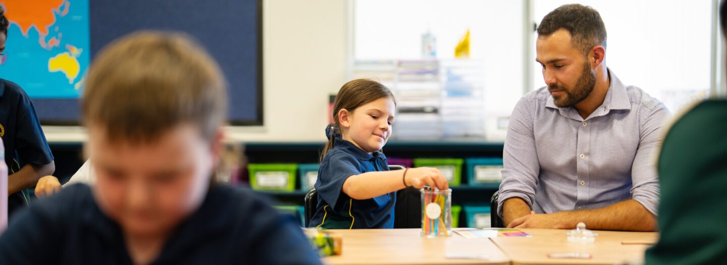 Student and teacher in a classroom.
